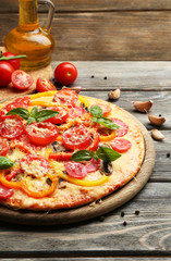 Delicious pizza served on wooden table