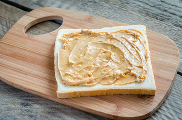 Sandwich with peanut butter on the wooden board