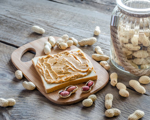 Sandwich with peanut butter on the wooden board