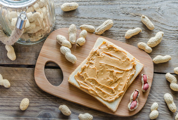 Sandwich with peanut butter on the wooden board