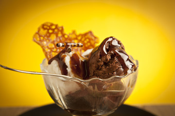 Ice cream in sundae cup on yellow background