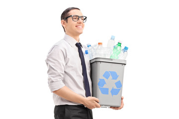 Young man carrying a recycle bin