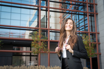 Fototapeta premium Portraig of a young business woman on a modern building backgrou