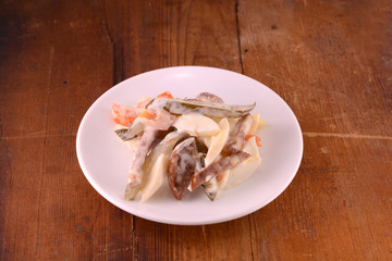 Healthy salad with fresh vegetables on wooden background
