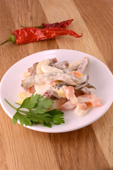 Healthy salad with fresh vegetables on wooden background