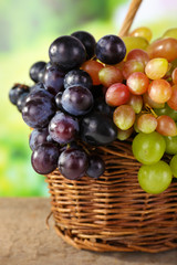 Grapes in basket on natural background