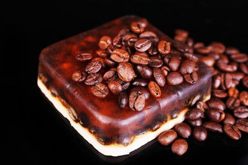 Organic soap with coffee beans, on dark background