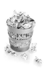 Money in dustbin isolated on white
