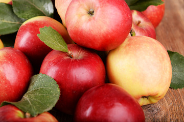 Ripe red apples on wooden background