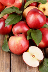 Ripe red apples on wooden background © Africa Studio