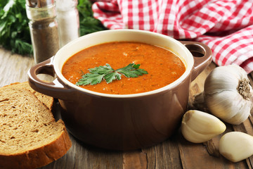 Delicious lentil cream-soup on table close-up