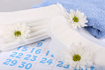 Sanitary pads, calendar, towel and white flowers