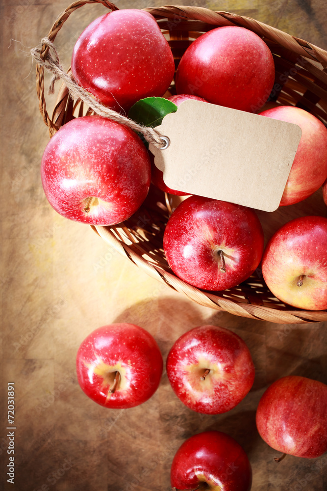 Wall mural Red apples with a tag in a basket - Wall murals