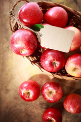 Red apples with a tag in a basket