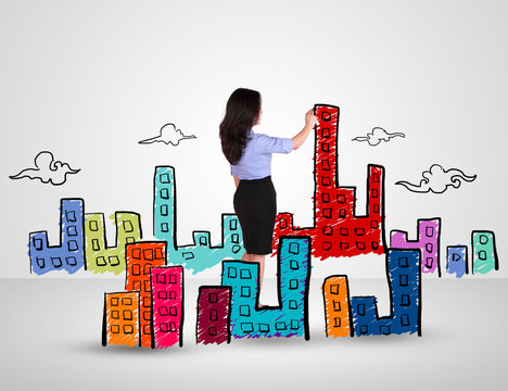 Business woman drawing city and building