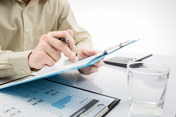 Close-up of graphs and charts analyzed by businessman