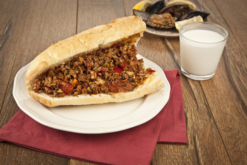Turkish Kokorec - lamb intestine food sandwich and ayran