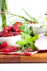 Assorted meats and sausages on a wooden board