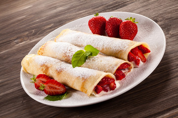 Pancakes with cream and strawberries