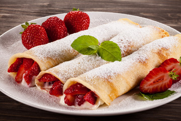 Pancakes with cream and strawberries
