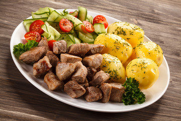 Grilled meat with boiled potatoes and vegetables