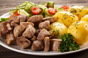 Grilled meat with boiled potatoes and vegetables
