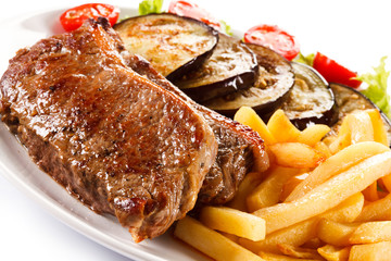 Grilled steak, French fries and vegetables