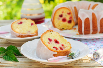 Obraz na płótnie Canvas A Slice of Lemon and Caraway Seed Bundt Cake with Raspberries