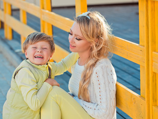 Mother with son at the autumn street