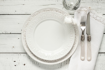 White table setting from above with elegant empty plate