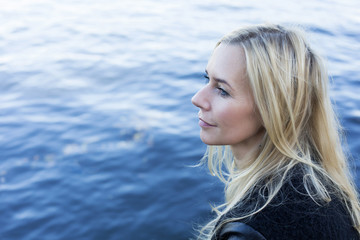 blond woman by the waterfront