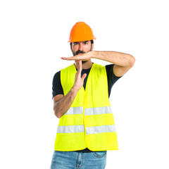Workman making time out gesture over white background