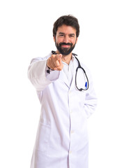 Doctor pointing to the front over white background