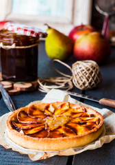 round apple tart with pear jam and caramel, vertically