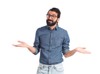 Young hipster man having doubts over white background