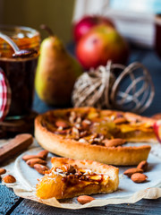piece of apple tart on a sand base with caramel