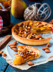 piece of apple tart on a sand base with caramel