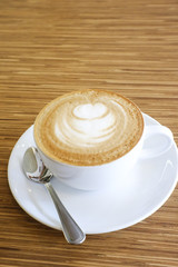 Hot Cappuccino with white cup on wood table coffehouse