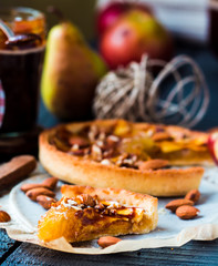 piece of apple tart on a sand base with caramel