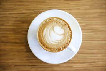 Hot Cappuccino with white cup on wood table coffehouse
