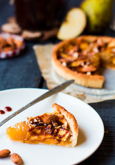 piece of apple tart on a white plate, spoon caramel