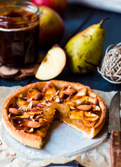 cut tart with pear jam, apples and caramel