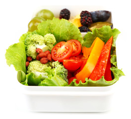 Tasty vegetarian food in plastic box, isolated on white