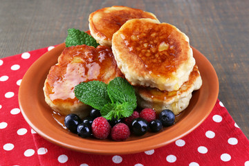 Tasty pancakes with fresh berries, honey and mint leaf