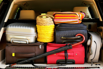 Suitcases and bags in trunk of car ready to depart for holidays