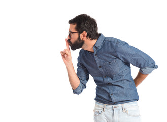 Young hipster man making silence gesture