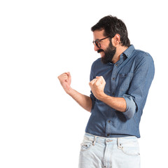 Lucky young hipster man over white background