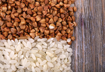 Rice and buckwheat on wooden background
