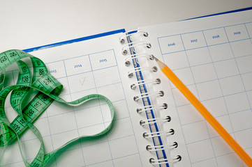 measuring tape and pencil on Planing Notes