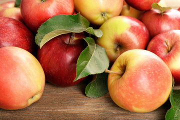 Ripe red apples on wooden background
